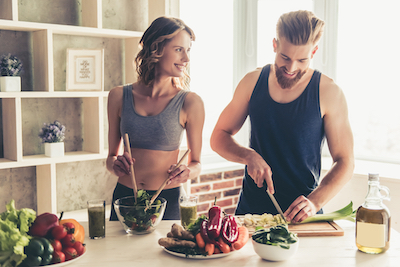 Happy healthy looking couple preparing a healthy meal